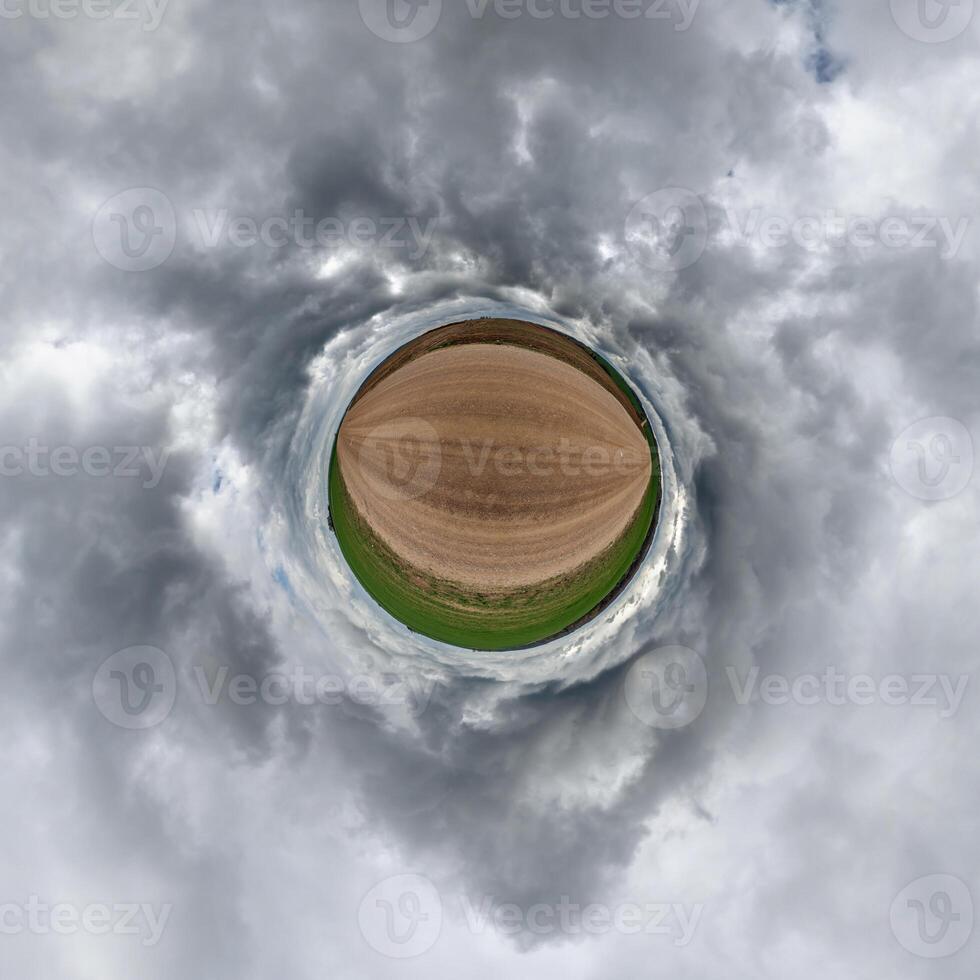 simple tiny planet without buildings in blue sky with beautiful clouds. Transformation of spherical panorama 360 degrees. Spherical abstract aerial view. Curvature of space. photo