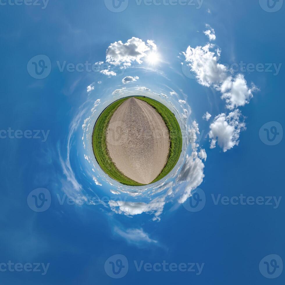 simple tiny planet without buildings in blue sky with beautiful clouds. Transformation of spherical panorama 360 degrees. Spherical abstract aerial view. Curvature of space. photo