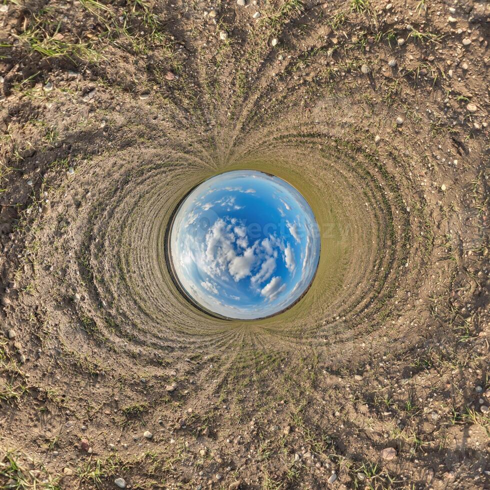 blue hole sphere little planet inside sand or dry grass round frame background photo