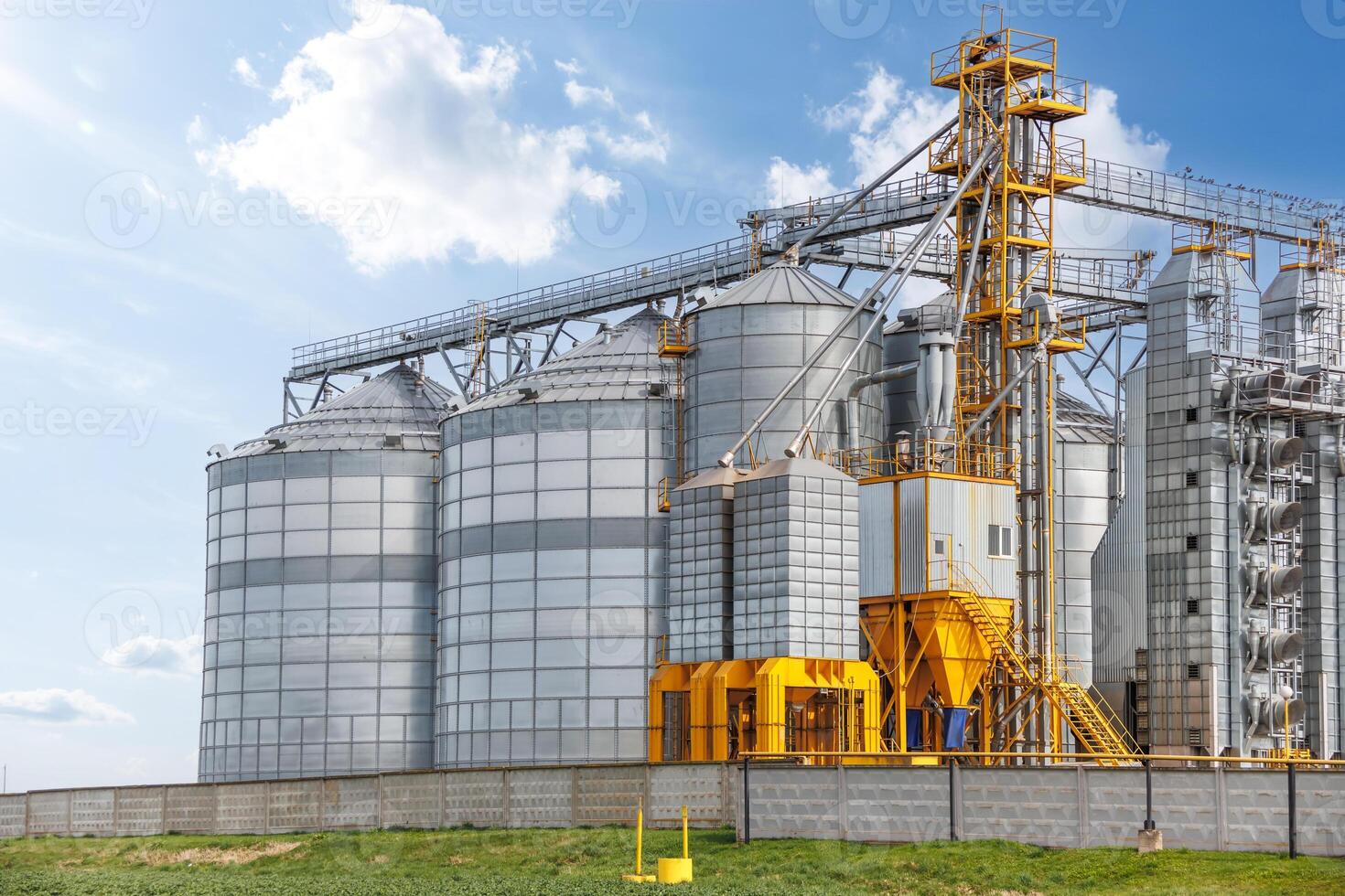 silos on agro-industrial complex with seed cleaning and drying line for grain storage photo