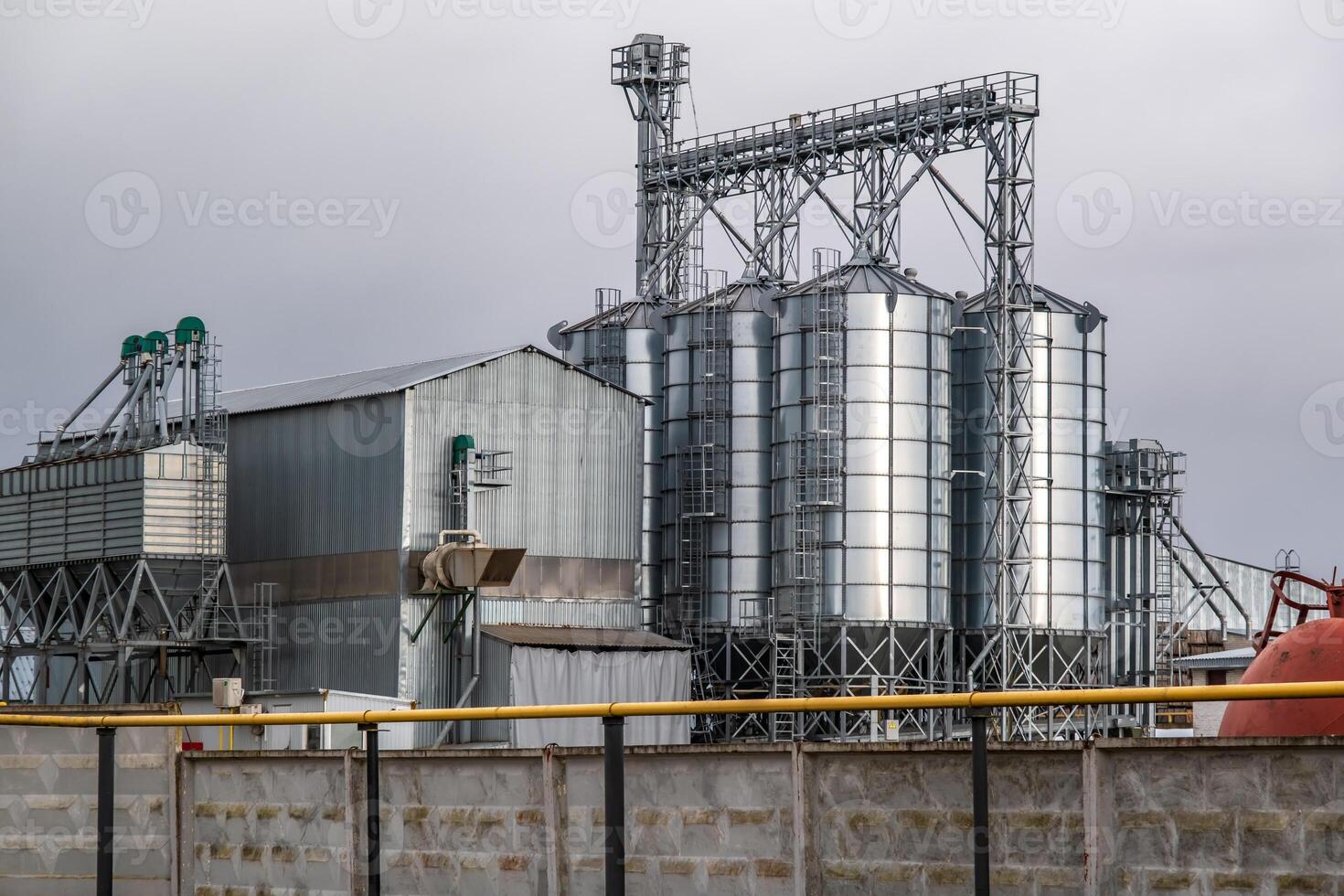 silos on agro-industrial complex with seed cleaning and drying line for grain storage photo