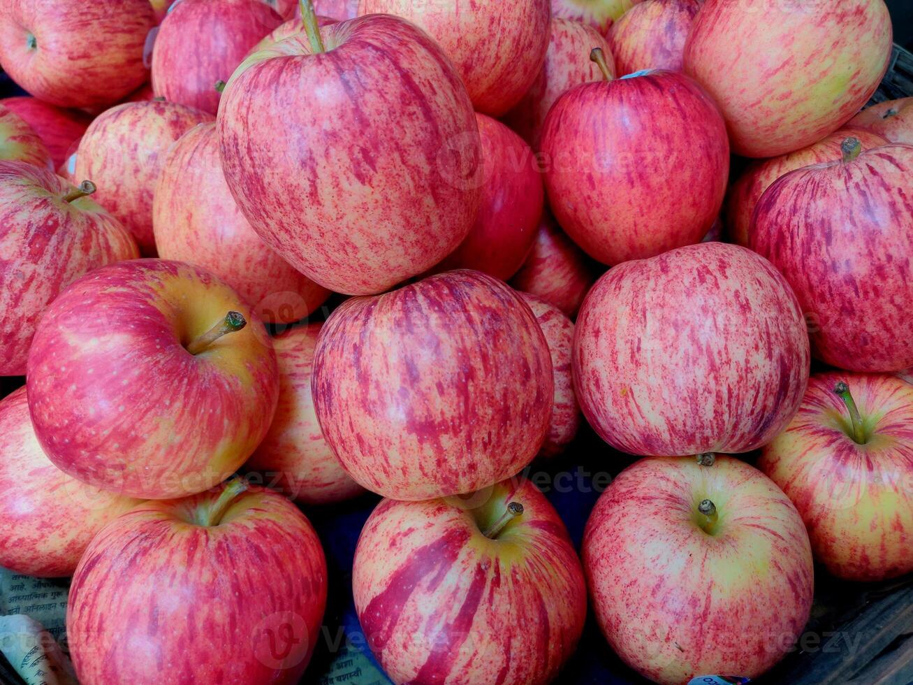 A jute basket full of hybrid apples kept for selling in the market photo