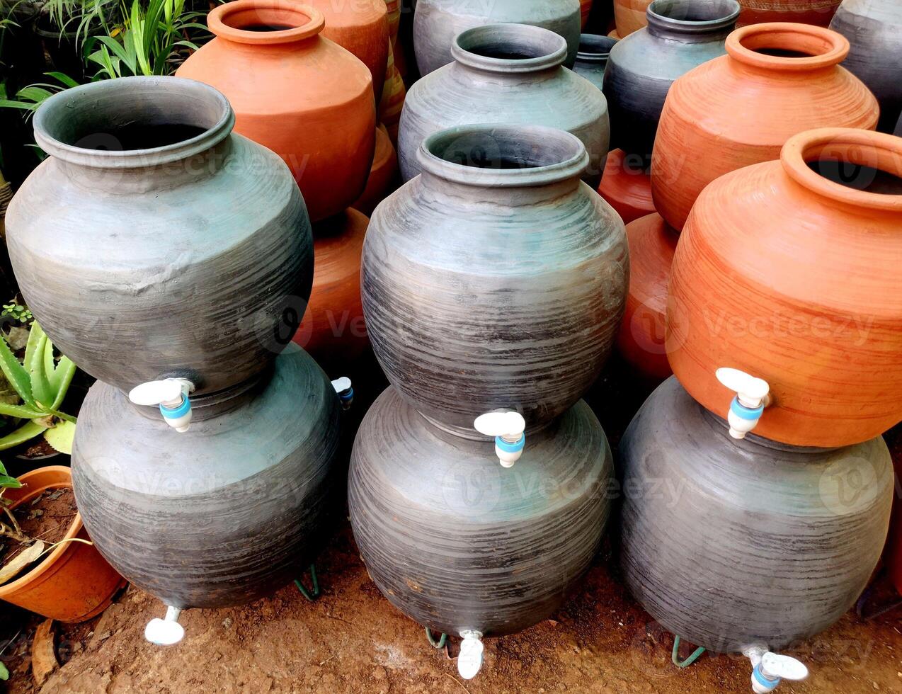 A clay water pot earthen pot for water storage Clay pots not only cool the water down, they also provide healing with the elements of earth. photo