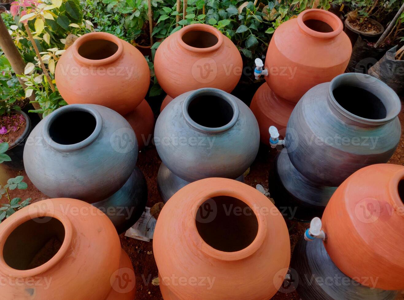 A clay water pot earthen pot for water storage Clay pots not only cool the water down, they also provide healing with the elements of earth. photo