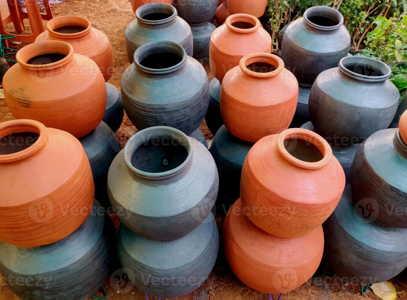 A clay water pot earthen pot for water storage Clay pots not only cool the water down, they also provide healing with the elements of earth. photo