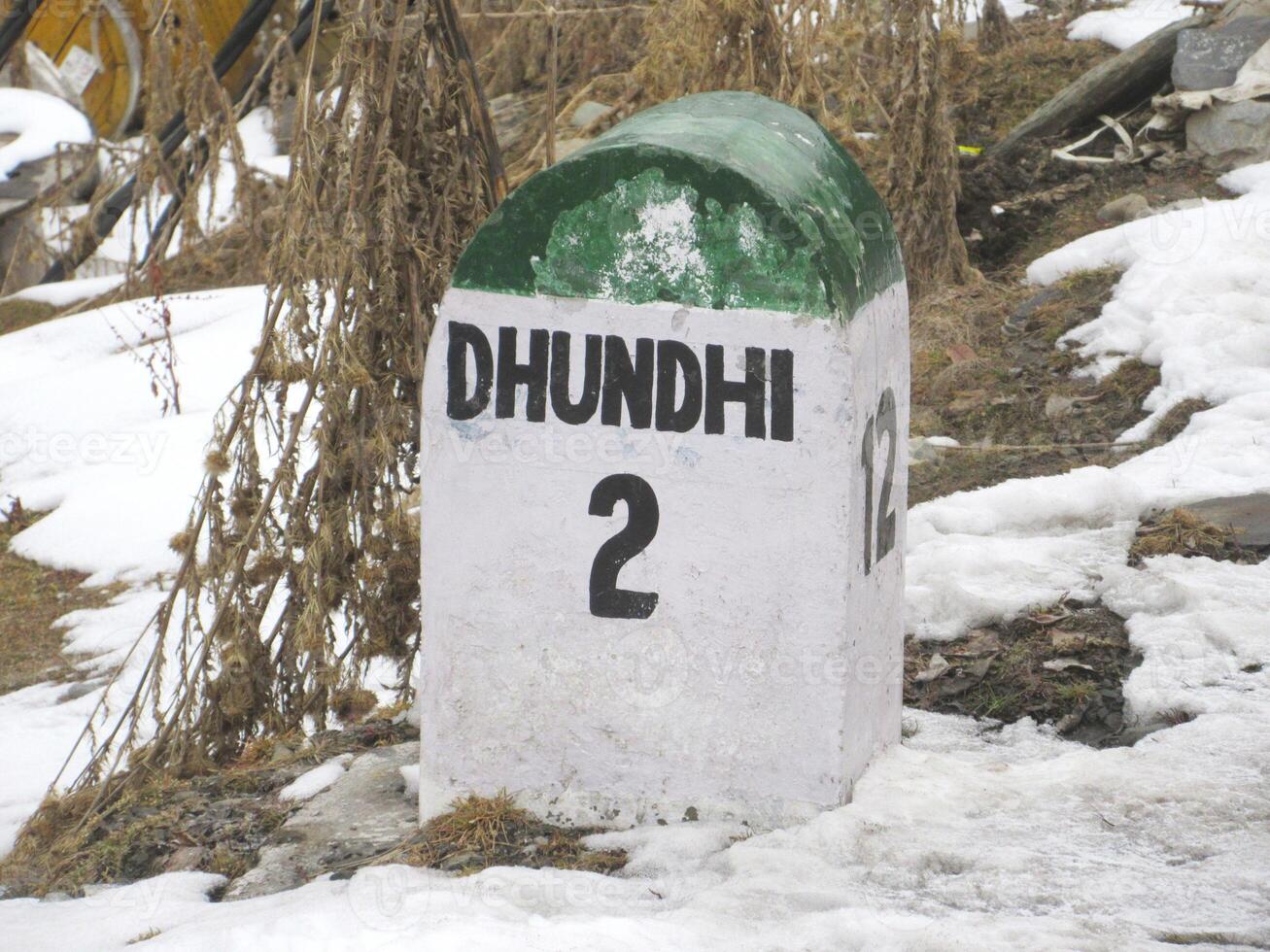 Dhundhi 2km ahead stone sign board Himachal Pradesh At a distance of 28 km from Manali Bus Stand and 15 km from Solang Valley photo