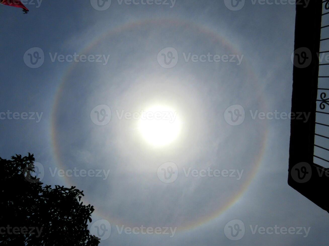 A 360-degree rainbow formed around the sun during midday as seen from ground photo