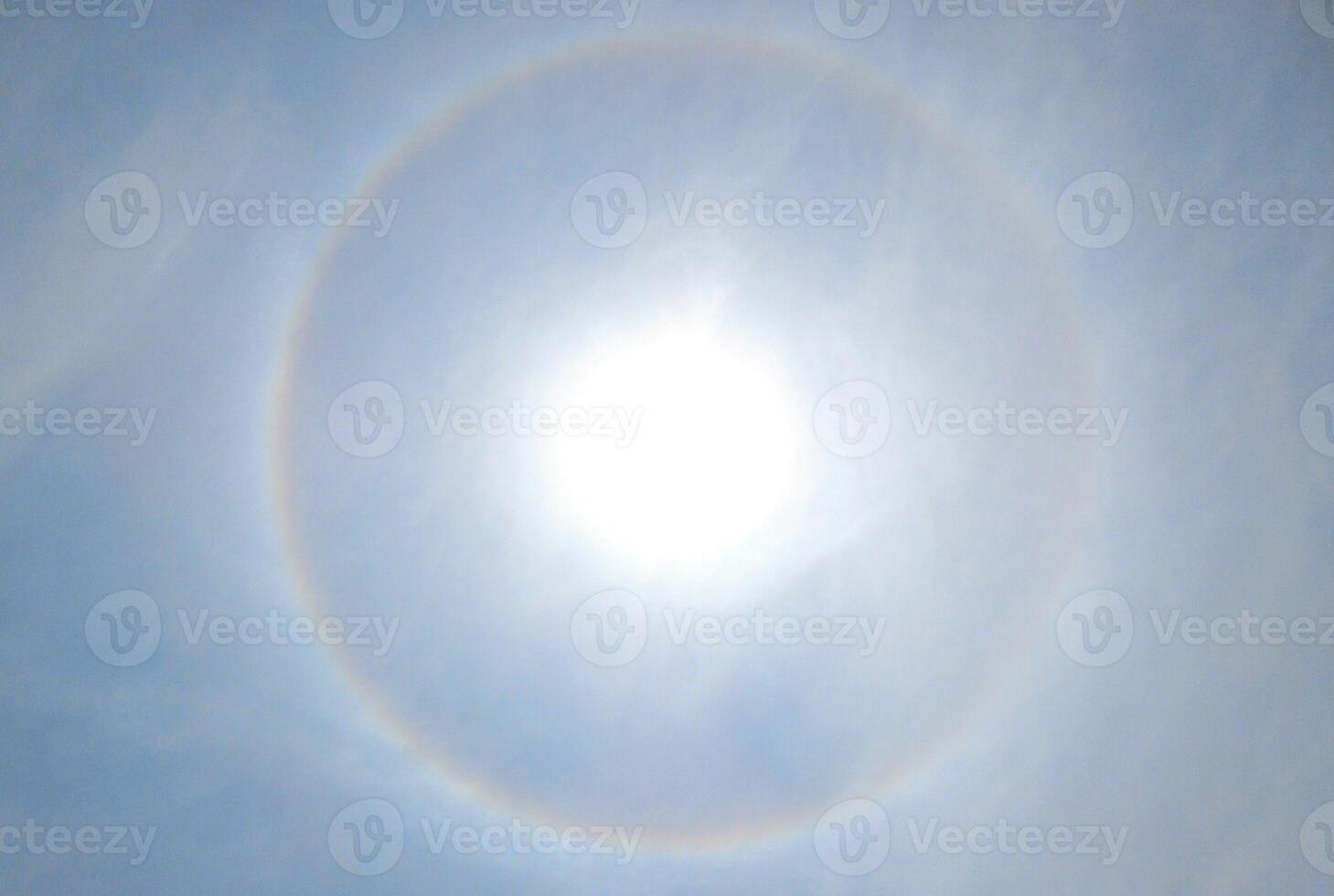 A 360-degree rainbow formed around the sun during midday as seen from ground photo