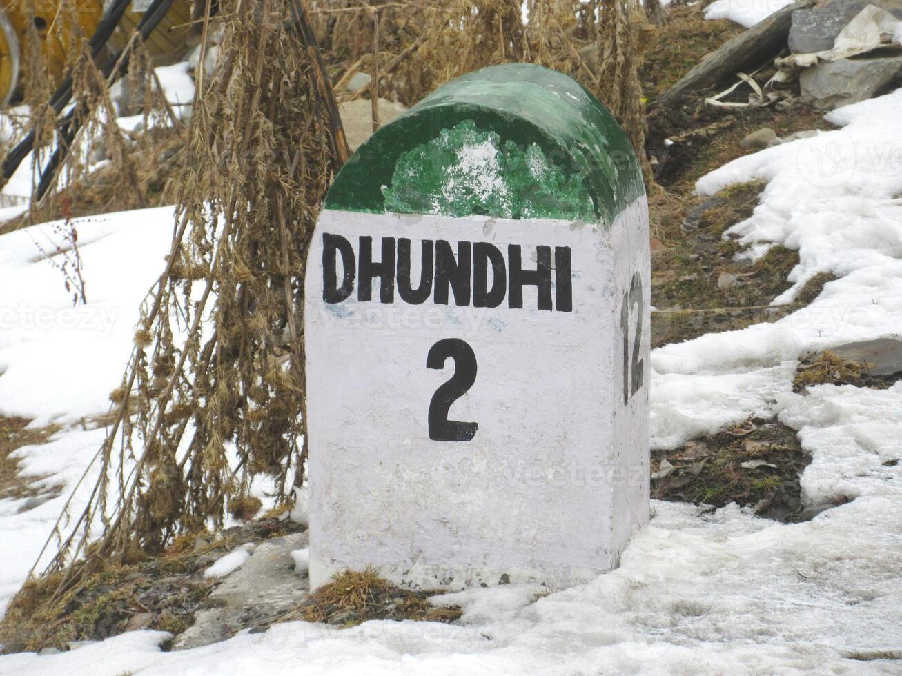 Dhundhi 2km ahead stone sign board Himachal Pradesh At a distance of 28 km from Manali Bus Stand and 15 km from Solang Valley photo
