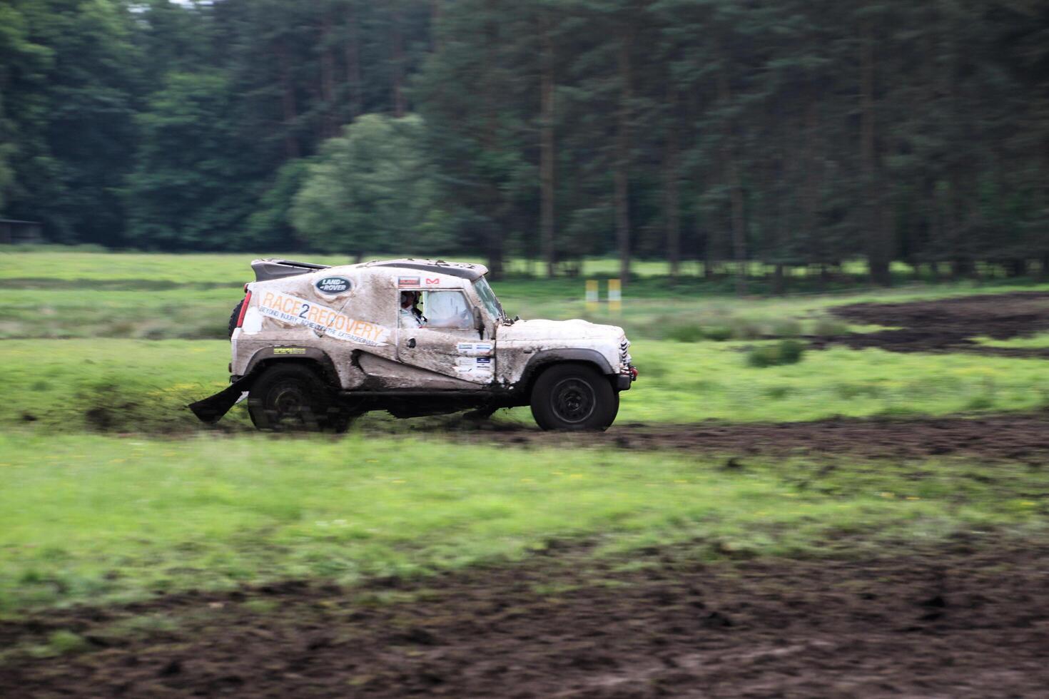 Malpas in Cheshire in the UK in September 2020. A view of a Landrover going through the mud in a field photo