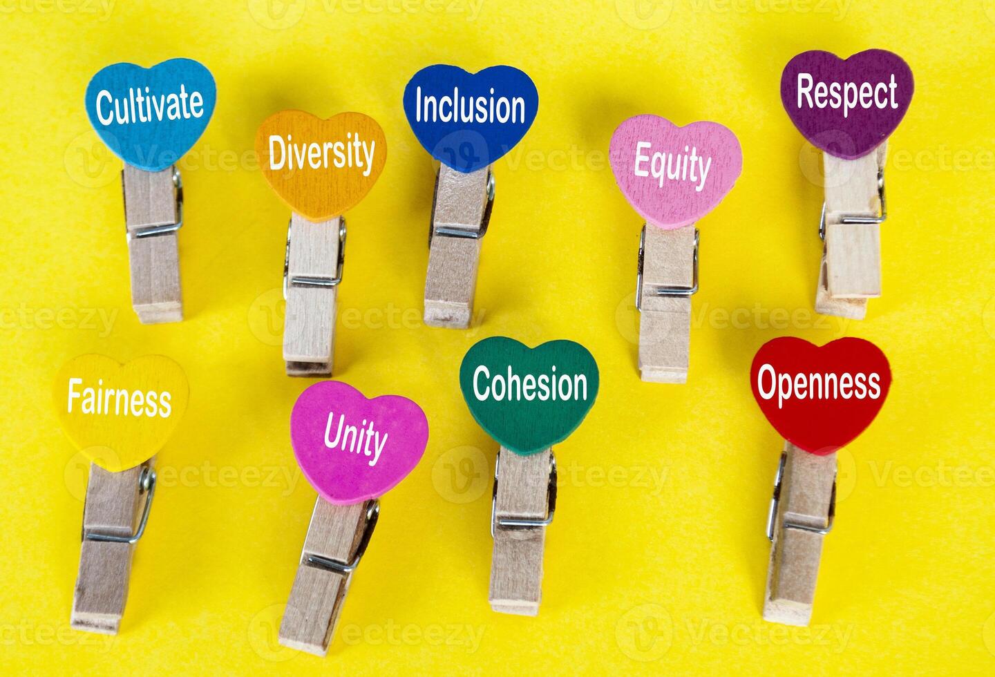 Cultivating respect of diversity and inclusion words on heart shape on yellow cover background. photo