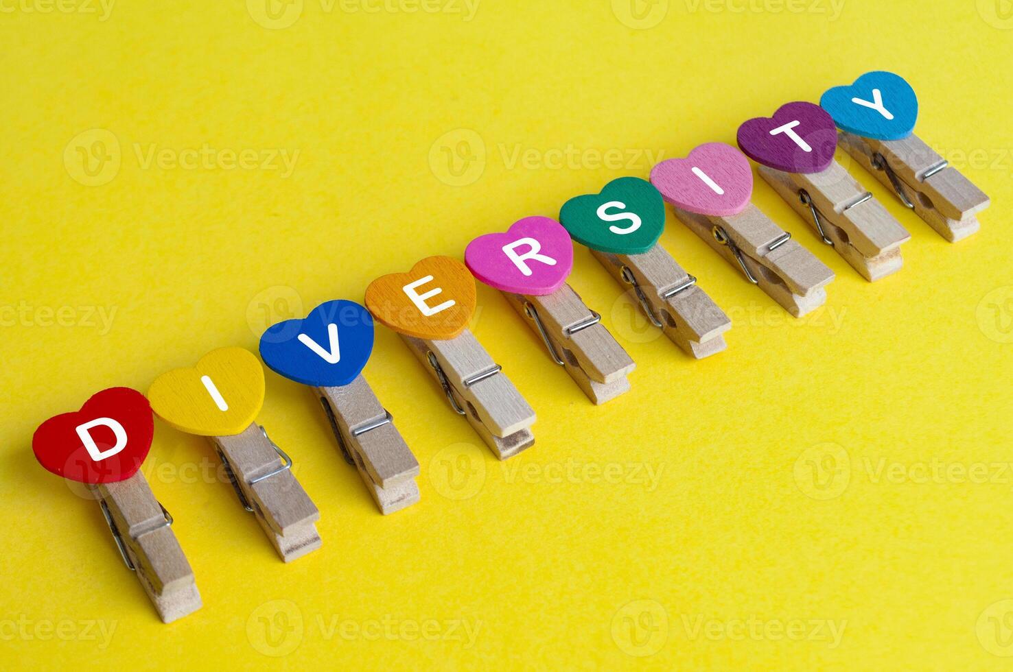 Diversity text on hearth shape on yellow background photo