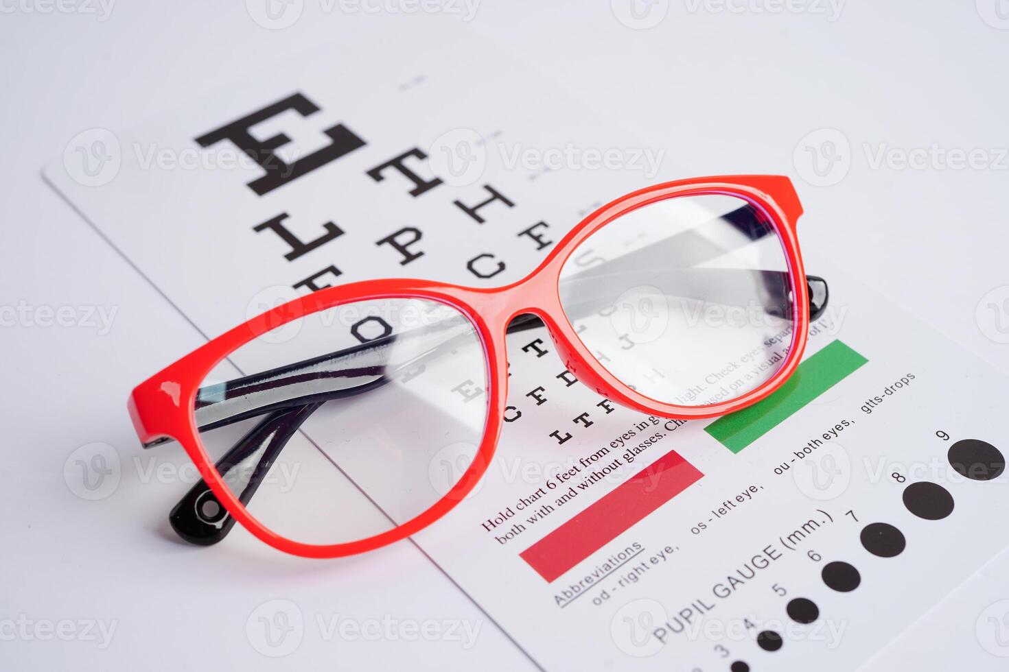 Glasses on eye exam chart to test eyesight accuracy of reading. photo