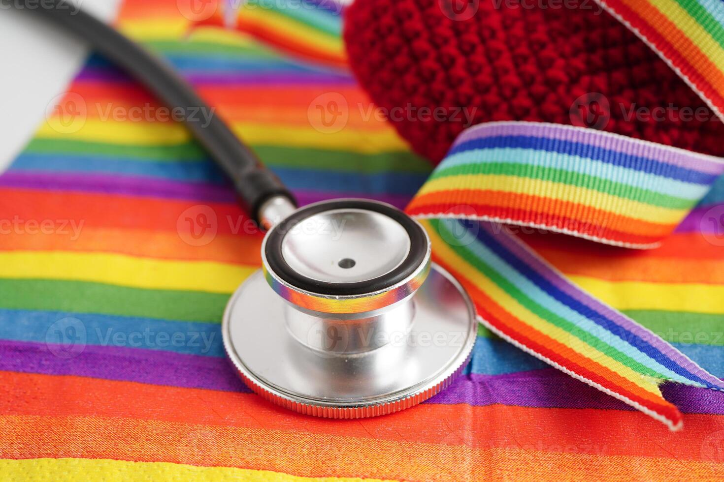 LGBT symbol, Stethoscope with red heart on rainbow flag, rights and gender equality, LGBT Pride Month in June. photo