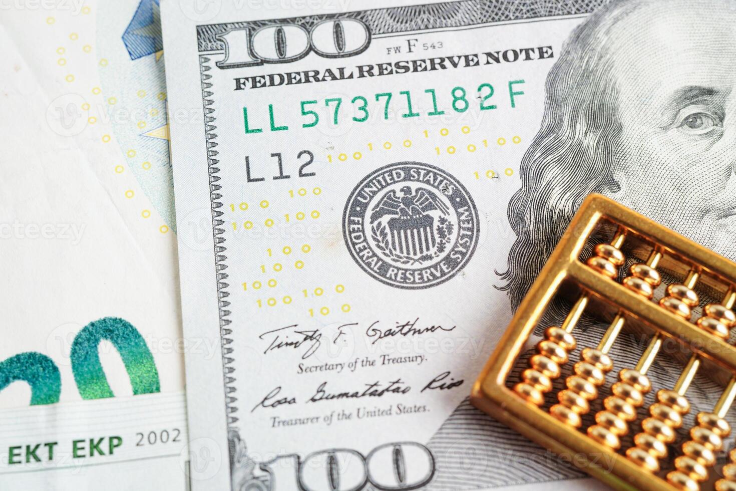 Gold abacus on banknote money, finance trading investment business currency concept. photo
