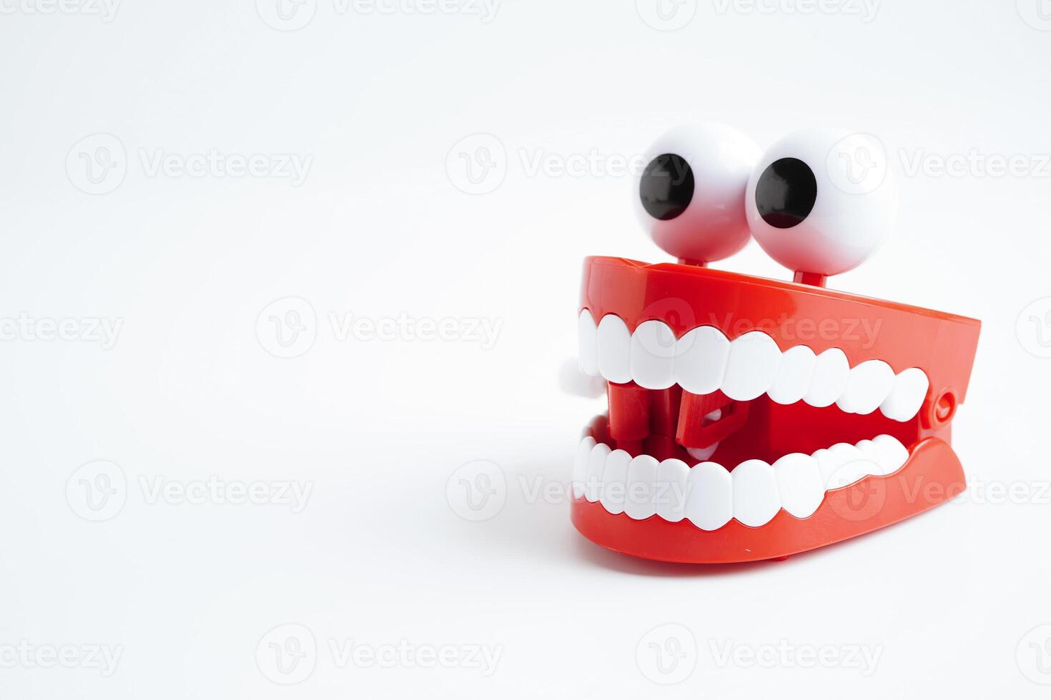 Funny red teeth with eye toy denture model for dental health care. photo