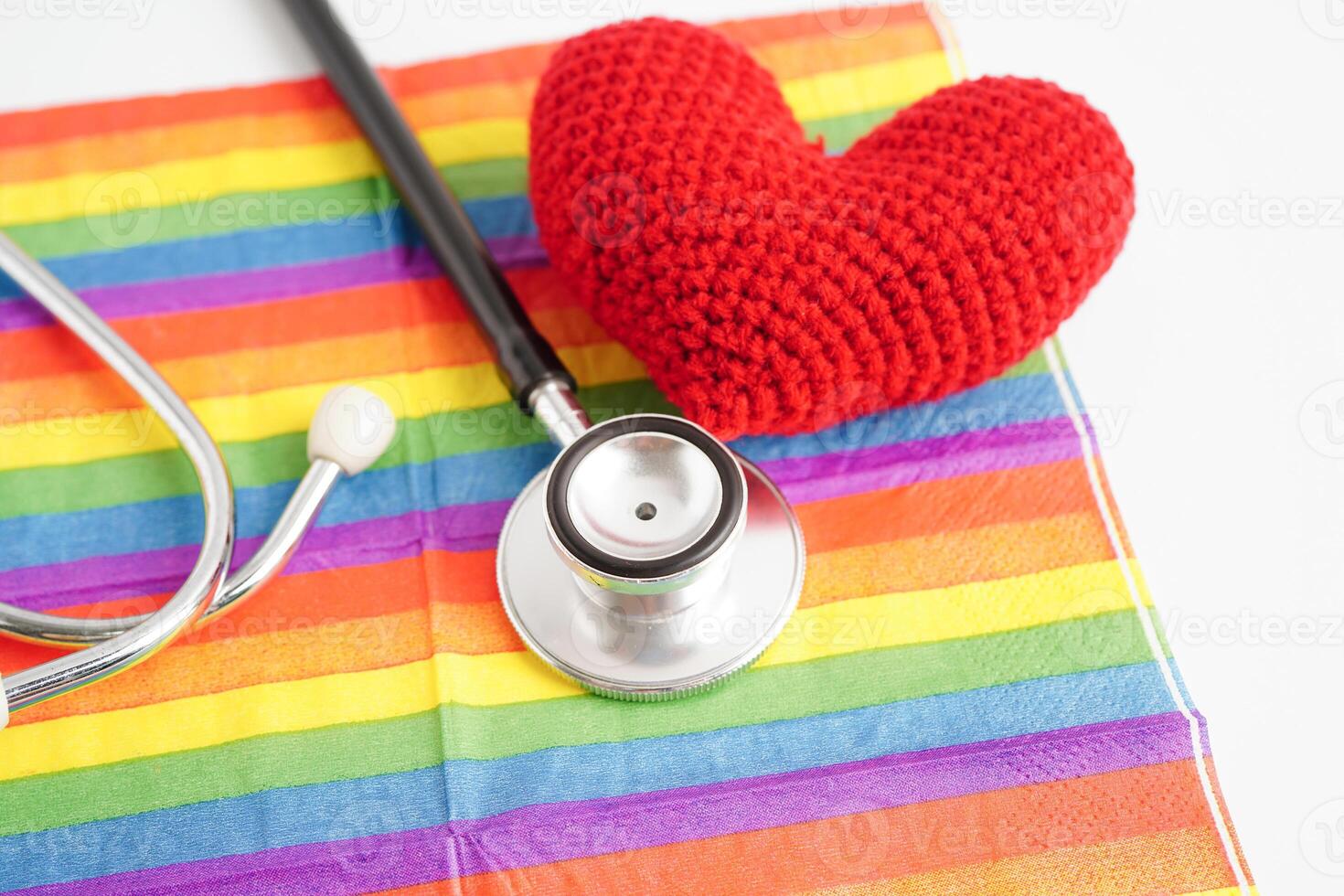 LGBT symbol, Stethoscope with red heart on rainbow flag, rights and gender equality, LGBT Pride Month in June. photo
