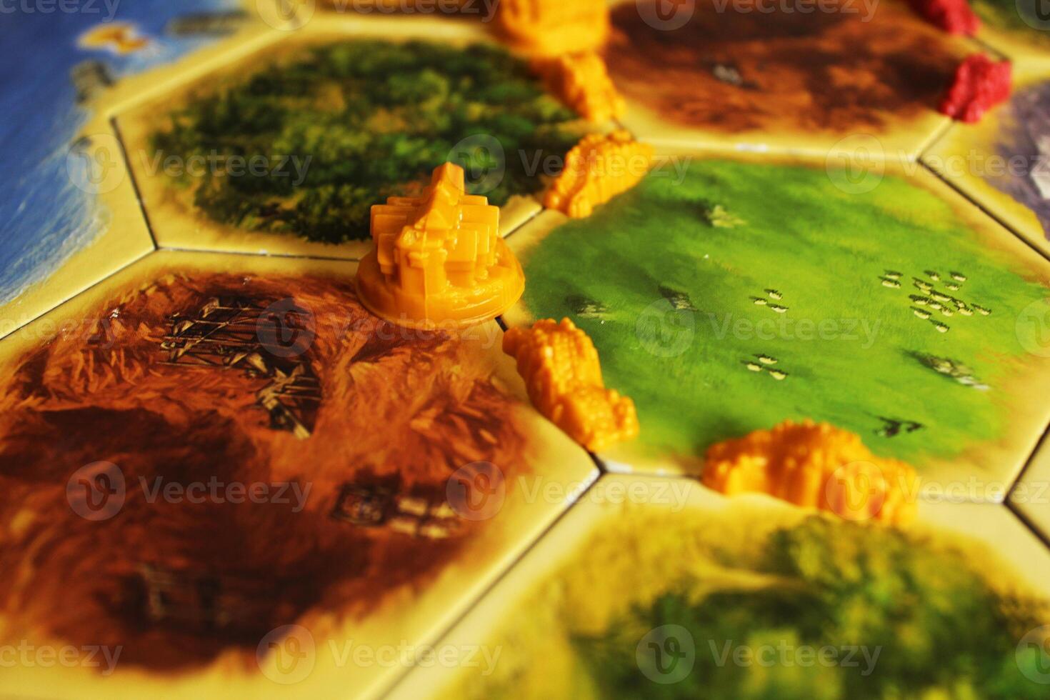 Mozyr, Belarus, April 01 2024. A catan board game yellow chips of the road and city player are put on the field. Rules for laying out roads and cities photo
