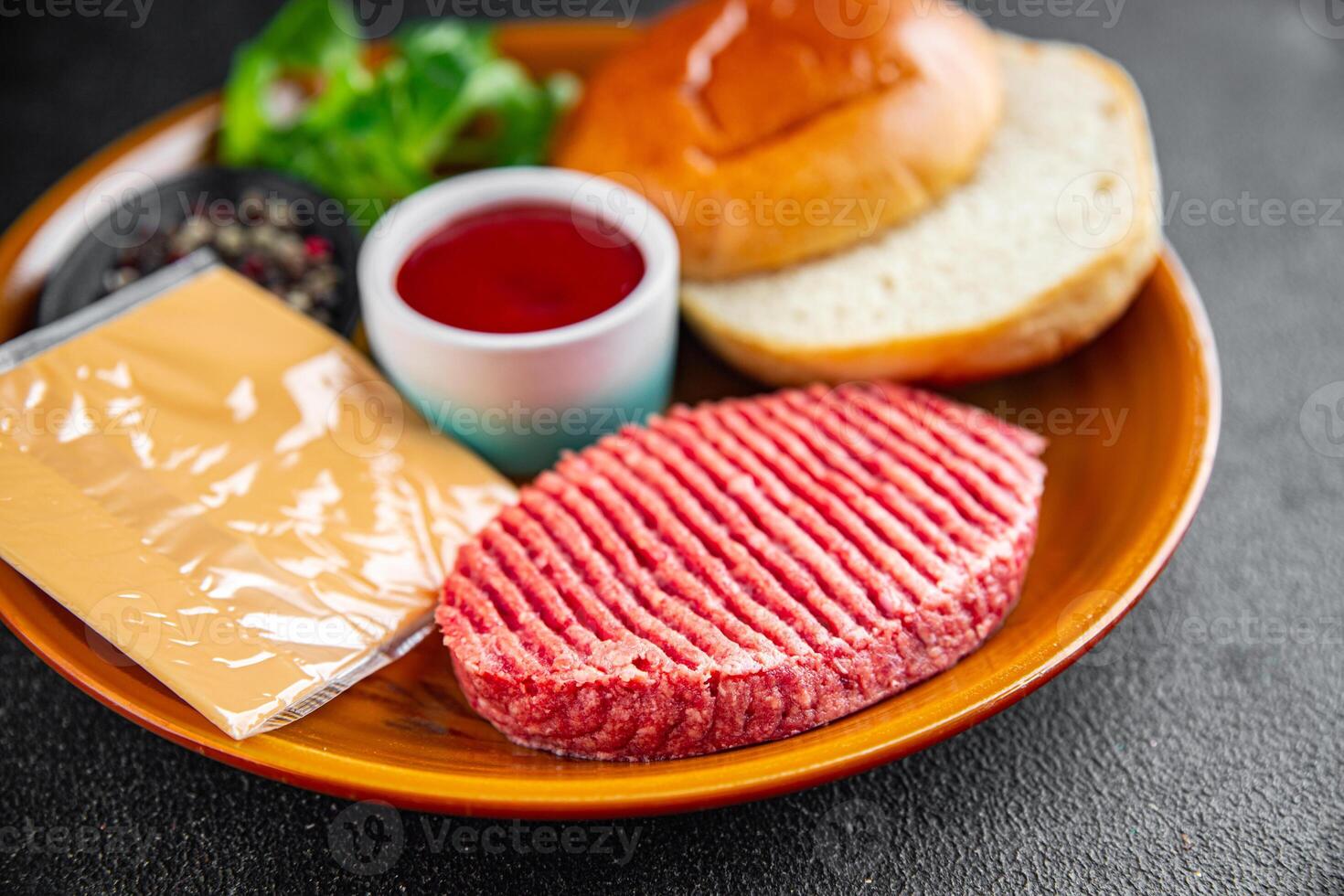 raw burger set cutlet, bun, cheese, tomato sauce, greens fresh cooking appetizer meal food snack on the table copy space food background rustic photo