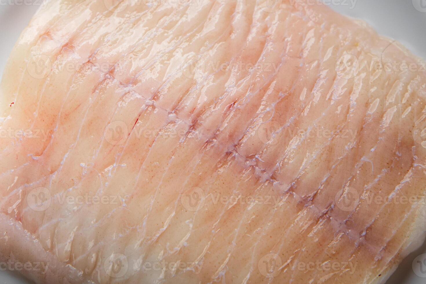 raw white fish fillet giant sea bass and filleting grouper fresh cooking appetizer meal food snack on the table copy space food background rustic top view Pescetarian diet vegetarian food photo