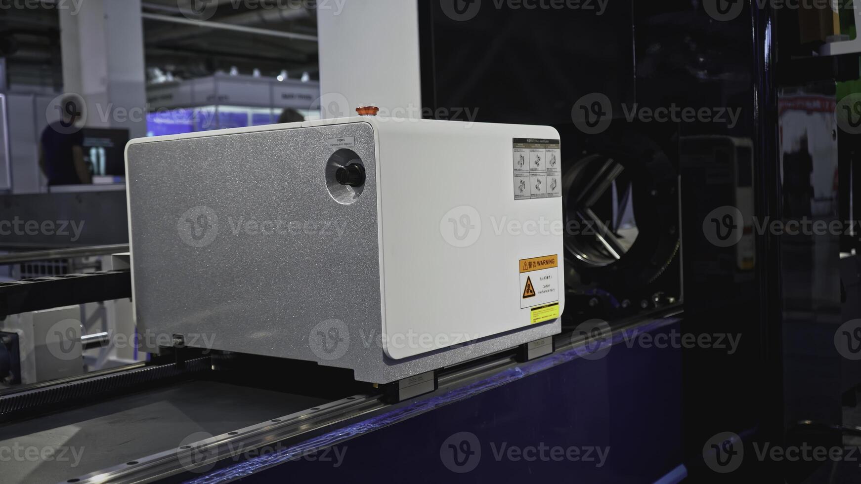 Automated laser cutting machine for metal pipes. Media. Moving machine on rails of industrial conveyor. Automated laser machine moving in industrial workshop photo
