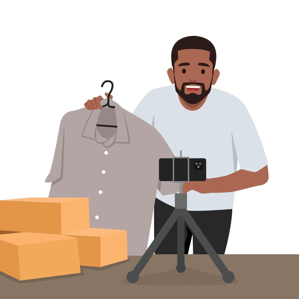 Young man is showing clothes in front of smartphone live streaming at his shop. vector