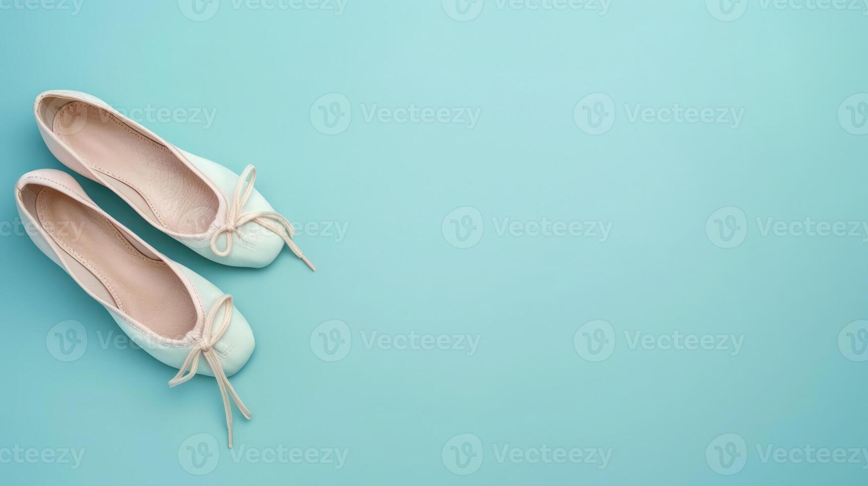 Pair of ballet shoes on a powder blue background with ample copyspace, elegant design photo
