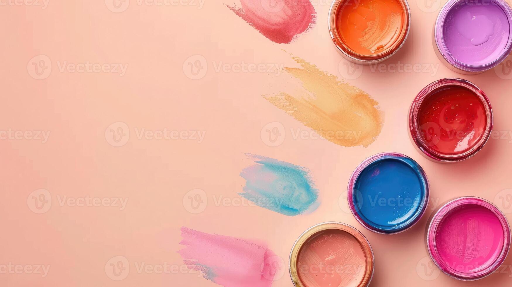 Artistic set of watercolor paints on a light peach background with abundant copyspace photo