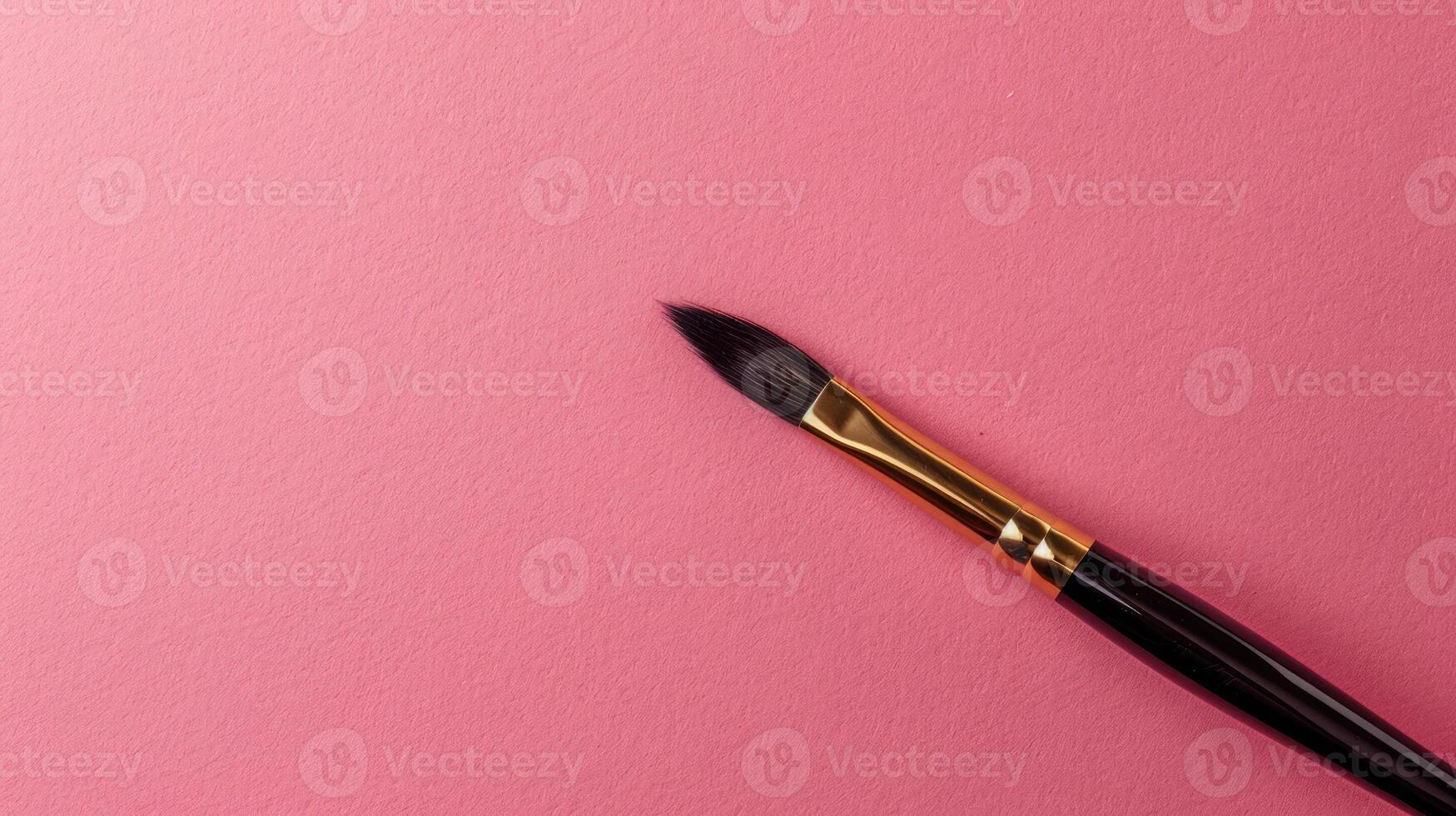 Calligraphy brush on a dusty rose background with ample copyspace, blending tradition and elegance photo