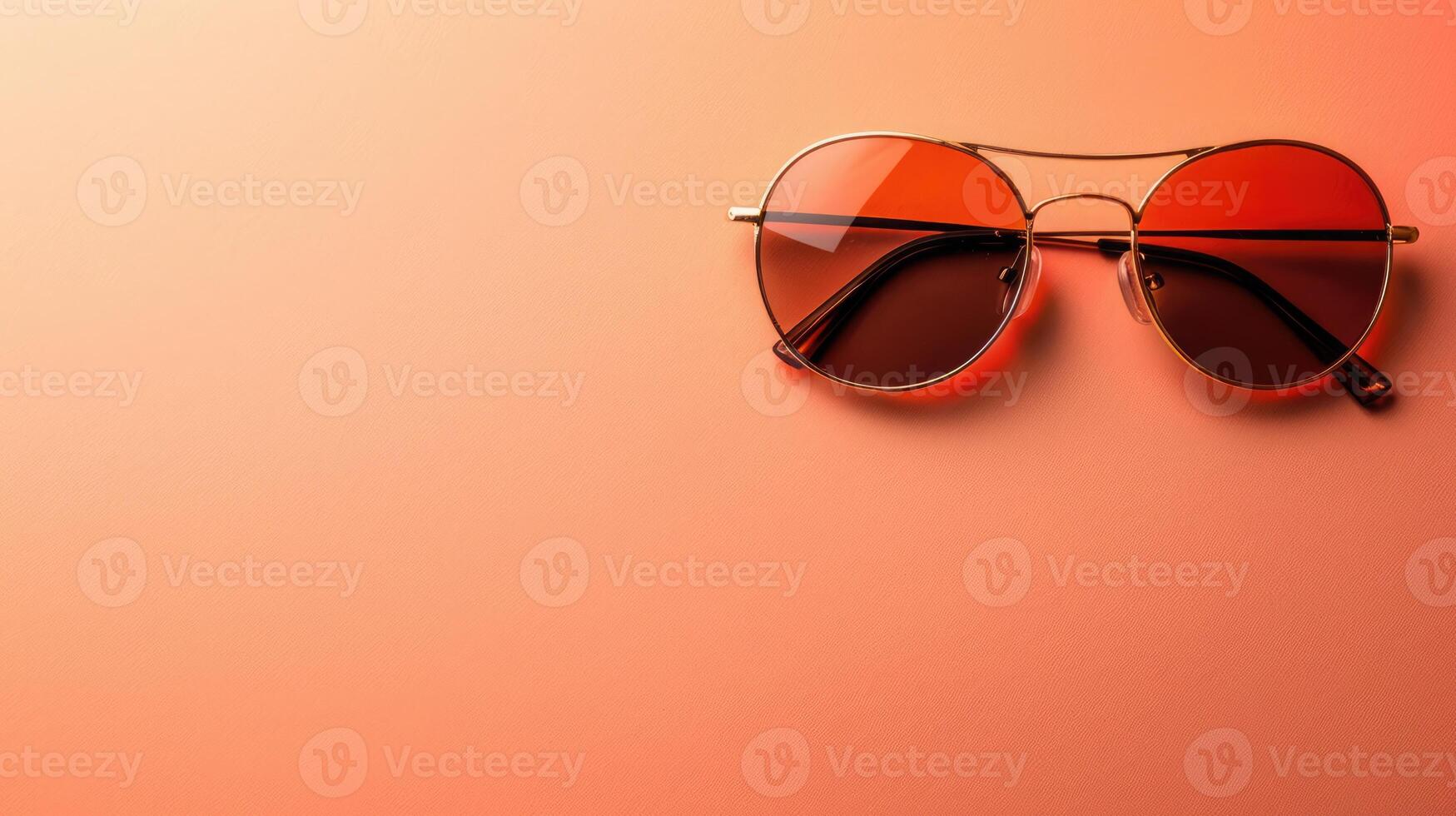 Peach background featuring a stylish pair of sunglasses with generous copyspace photo