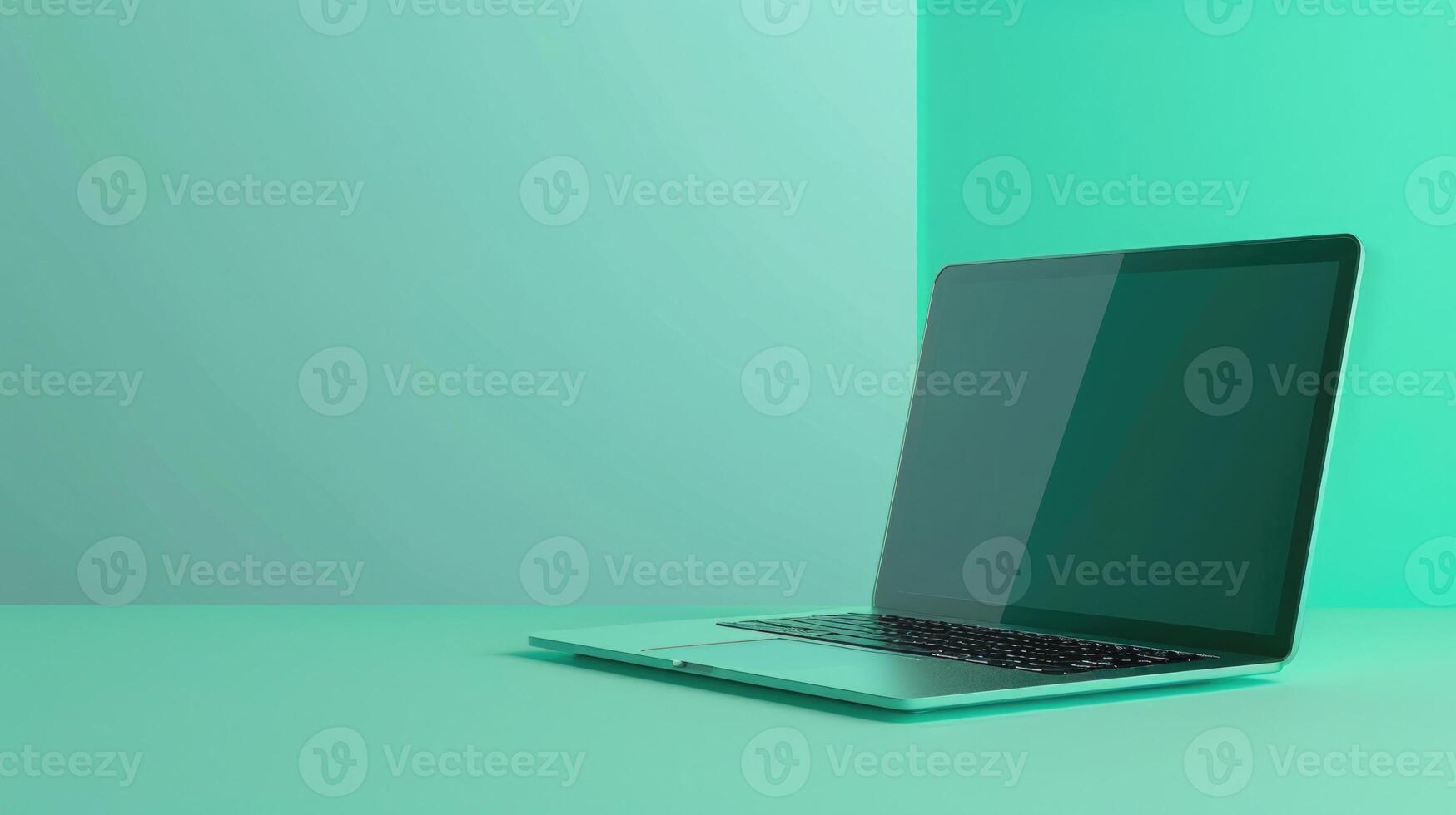 Artistic laptop on a mint green background with abundant copyspace photo