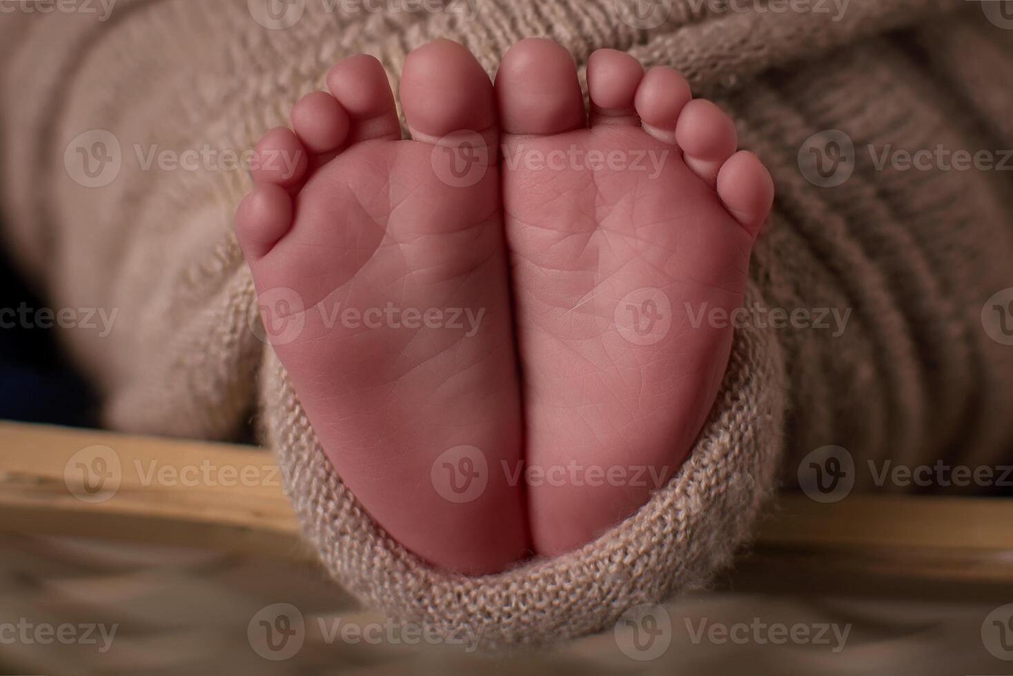Parent holding in the hands feet of newborn baby. photo