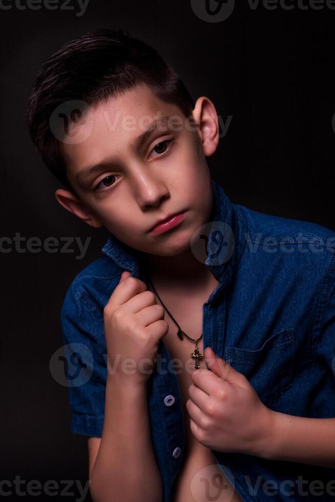 boy posing on a black background . close-up photo