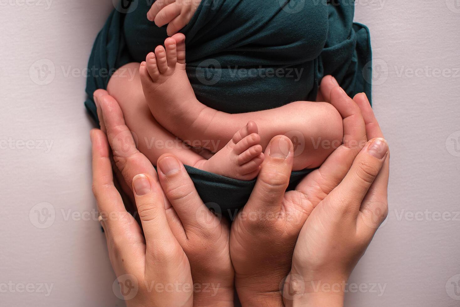 Parent holding in the hands feet of newborn baby. photo