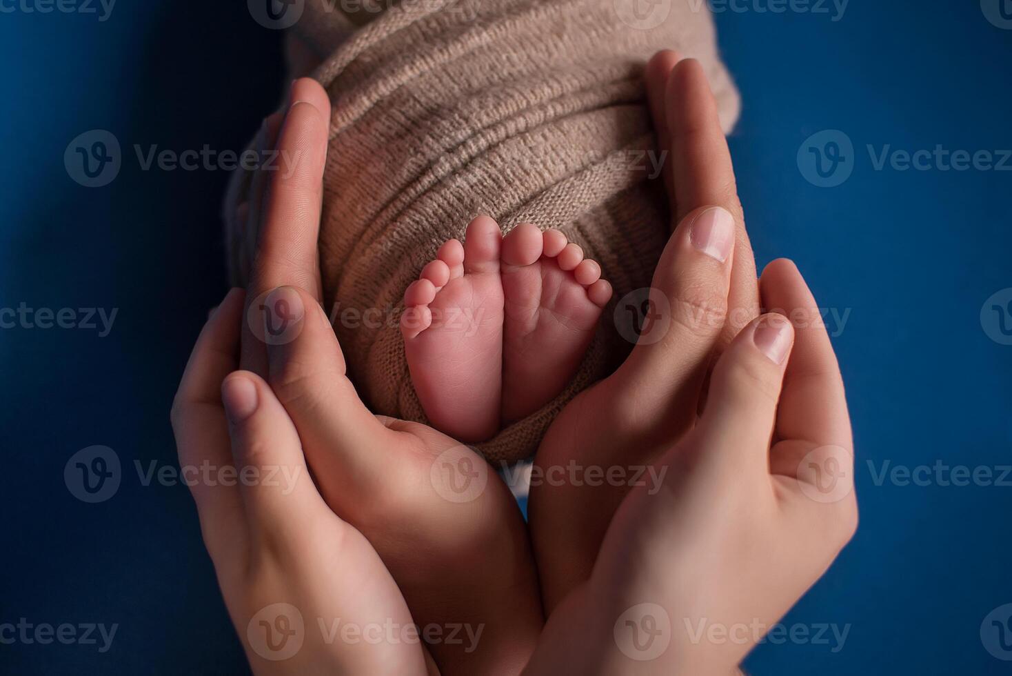 Parent holding in the hands feet of newborn baby. photo