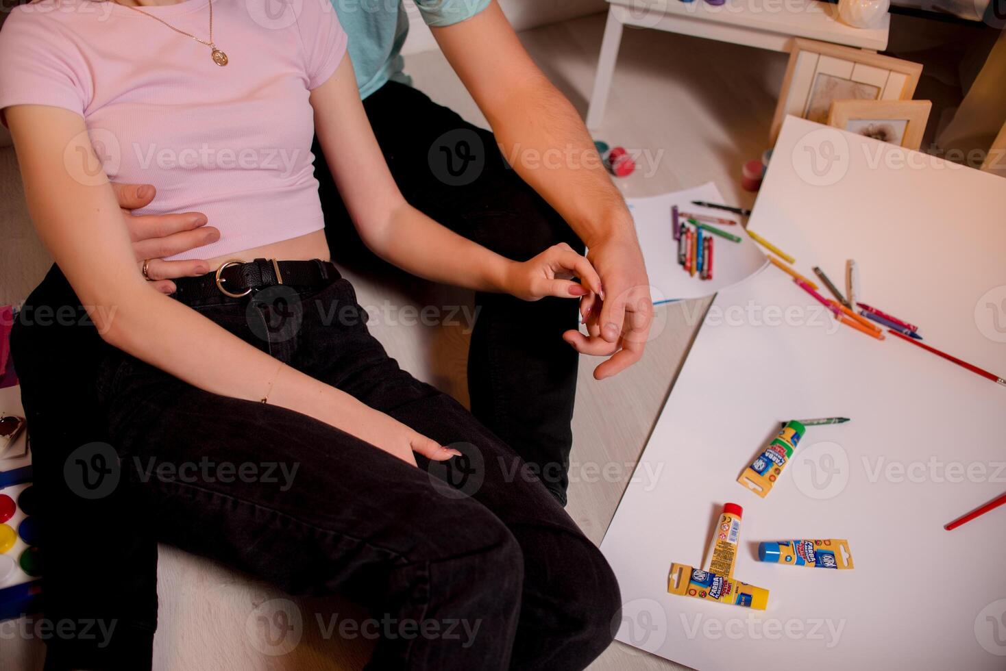 Two lovers draw with paints. Two lovers draw with paints. Hands are covered with paint . photo