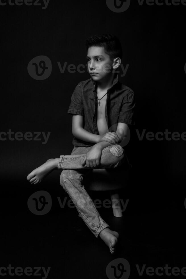 boy posing on a black background . close-up photo