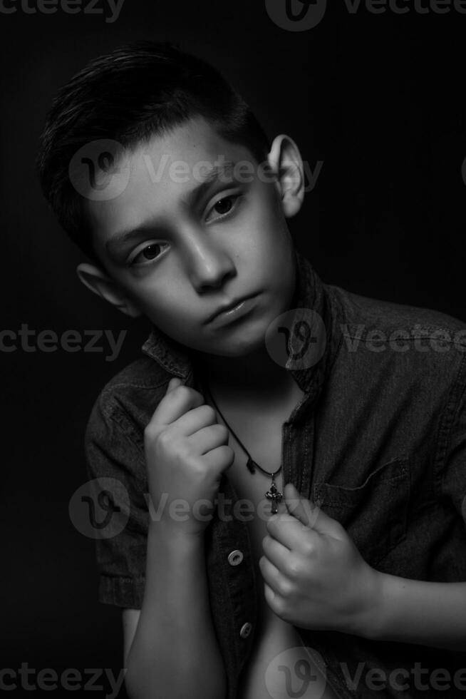 boy posing on a black background . close-up photo