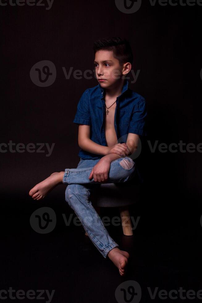 boy posing on a black background . close-up photo