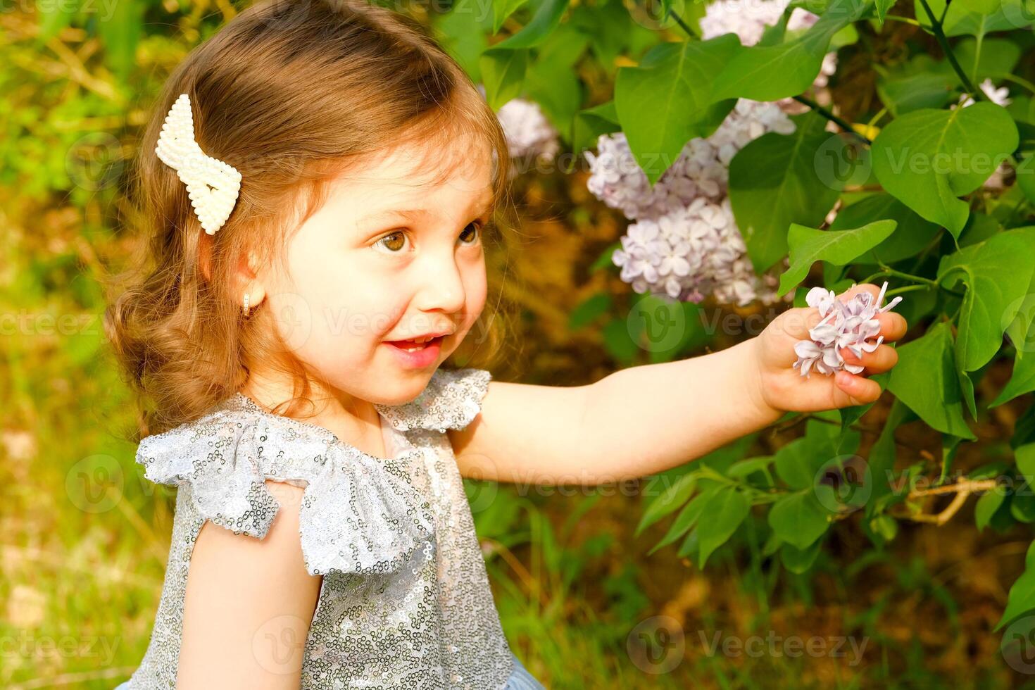 child walks in the park. little girl dressed in a blue dress. photo
