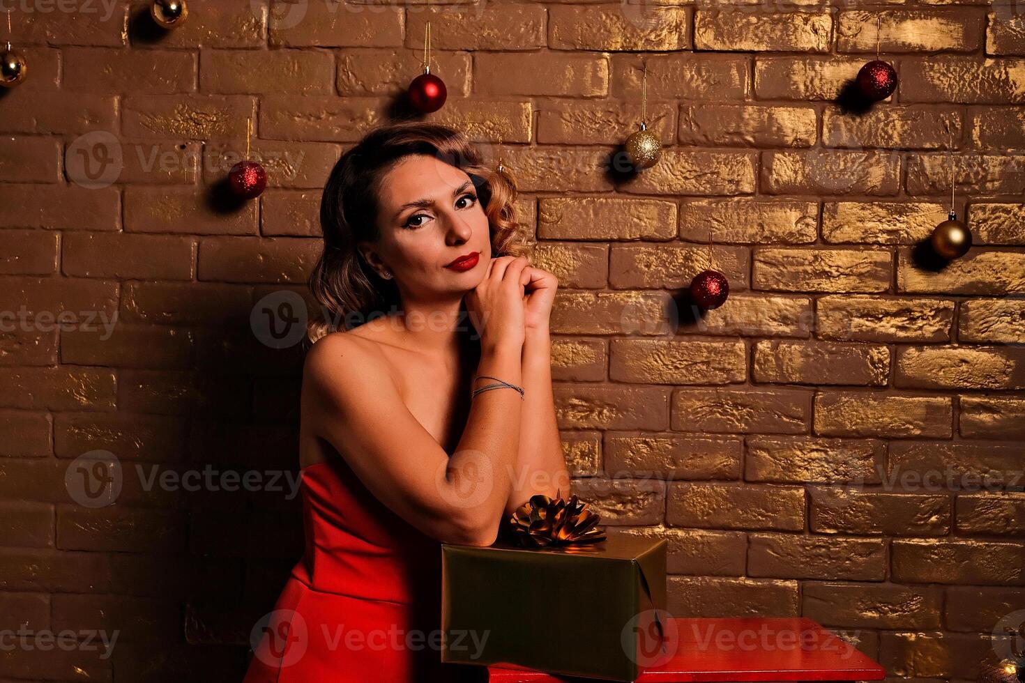 the girl received a gift. girl in a red dress. holiday gift. photo