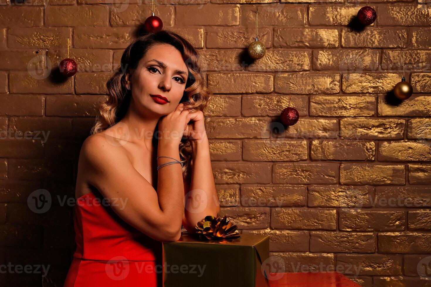 the girl received a gift. girl in a red dress. holiday gift. photo