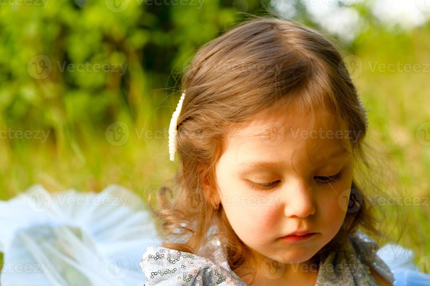 child walks in the park. little girl dressed in a blue dress. photo