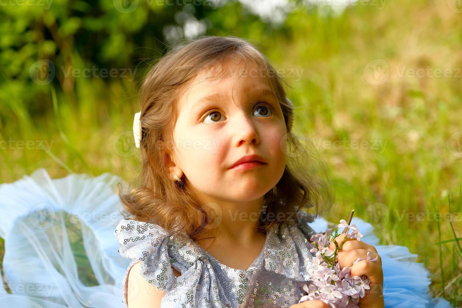 child walks in the park. little girl dressed in a blue dress. photo