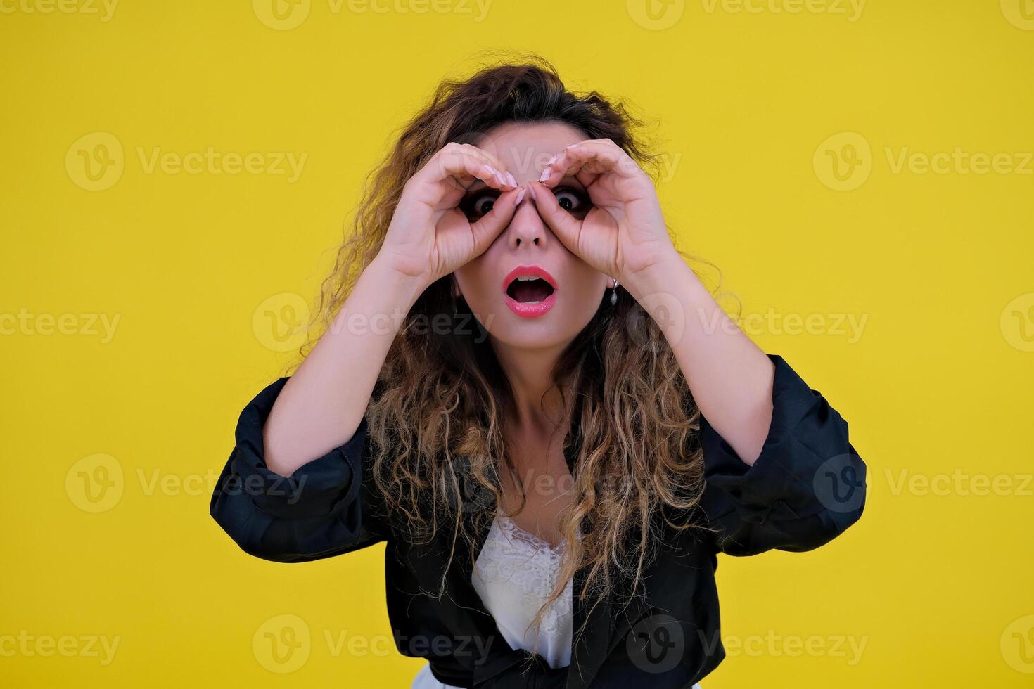 Close-up portrait of a beautiful girl on a yellow background. woman looks out for advertising space, advertises copy space photo