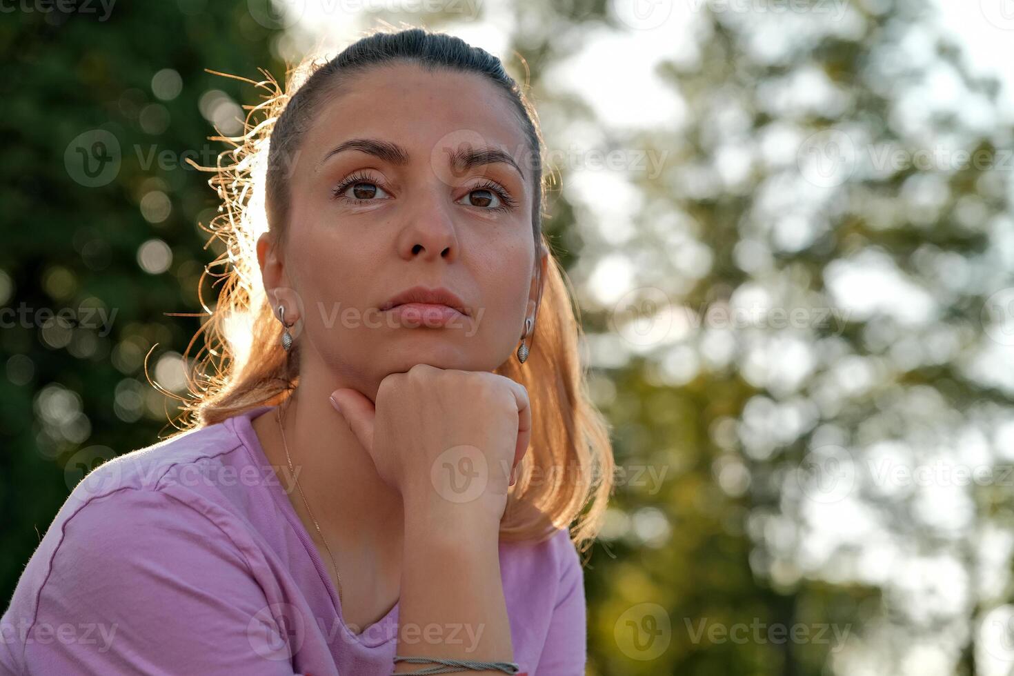 pensive girl looks into the distance. brunette looks into the distance. photo