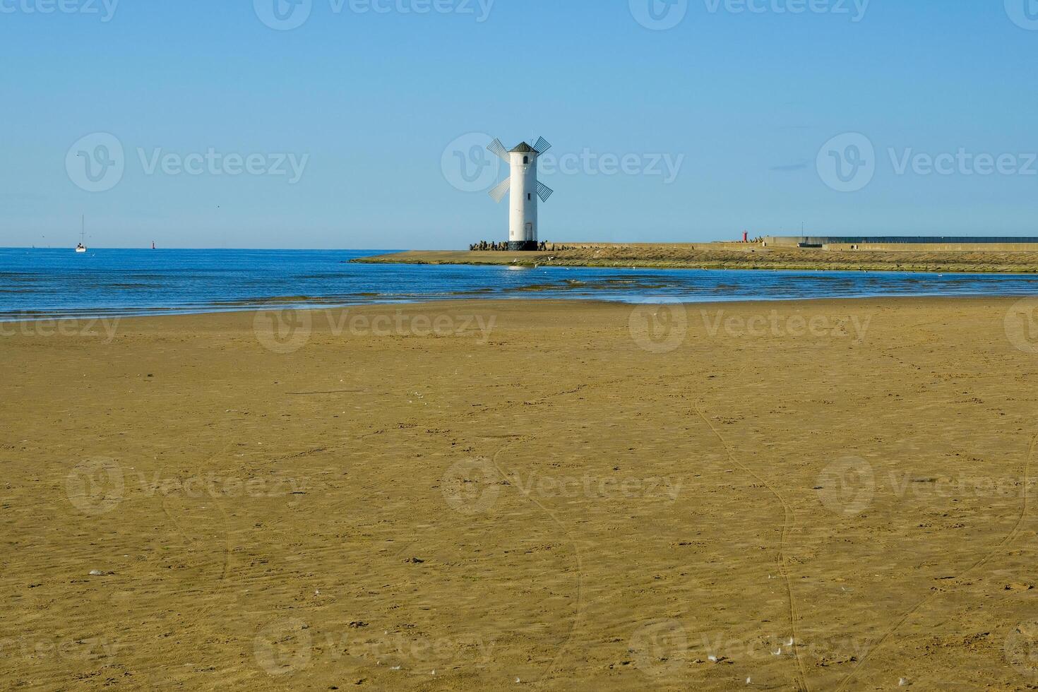 Old lighthouse in Swinoujscie, a port in Poland on the Baltic Sea. The lighthouse was designed as a traditional windmill. Panoramic image. old mill. lighthouse photo