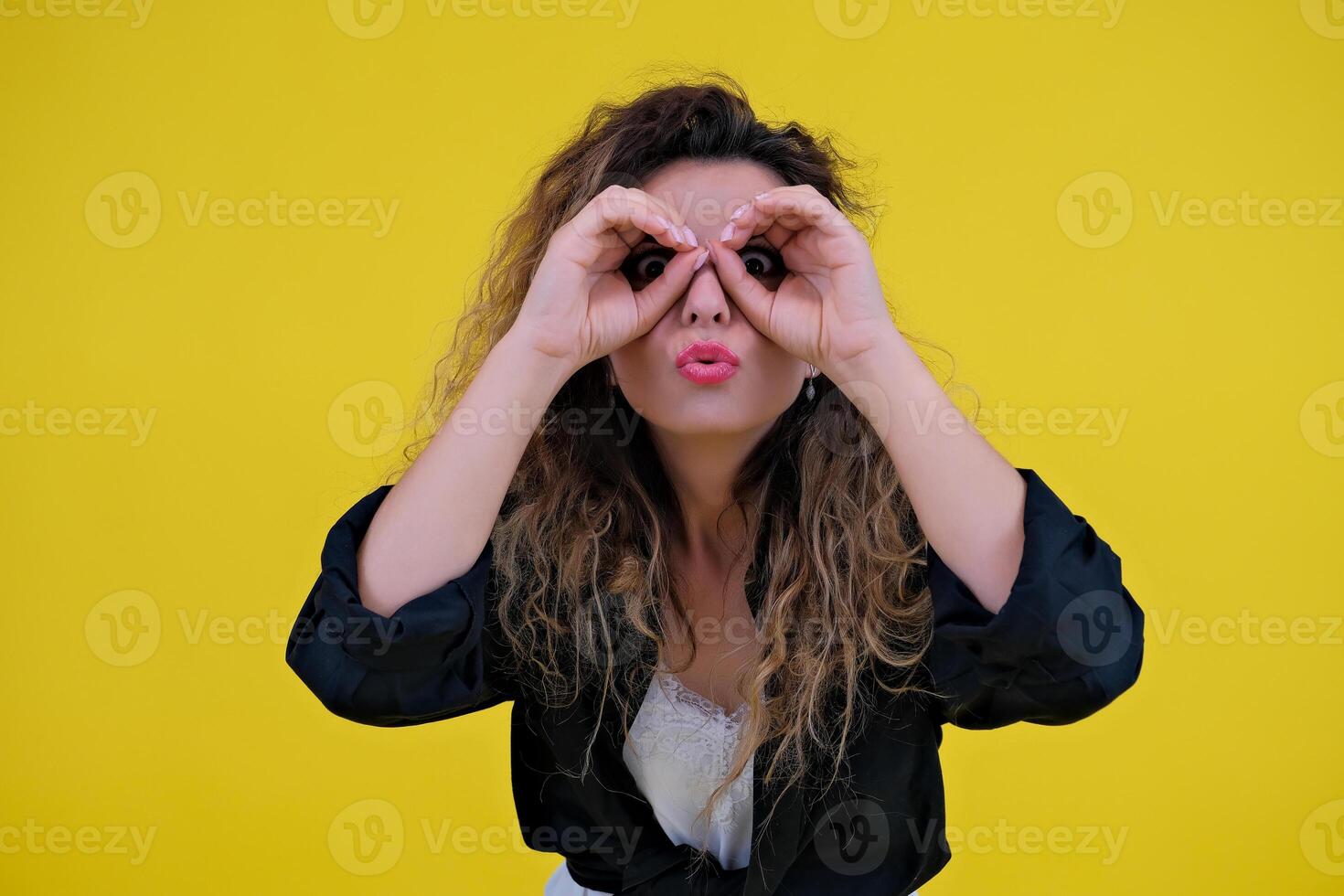 Close-up portrait of a beautiful girl on a yellow background. woman looks out for advertising space, advertises copy space photo