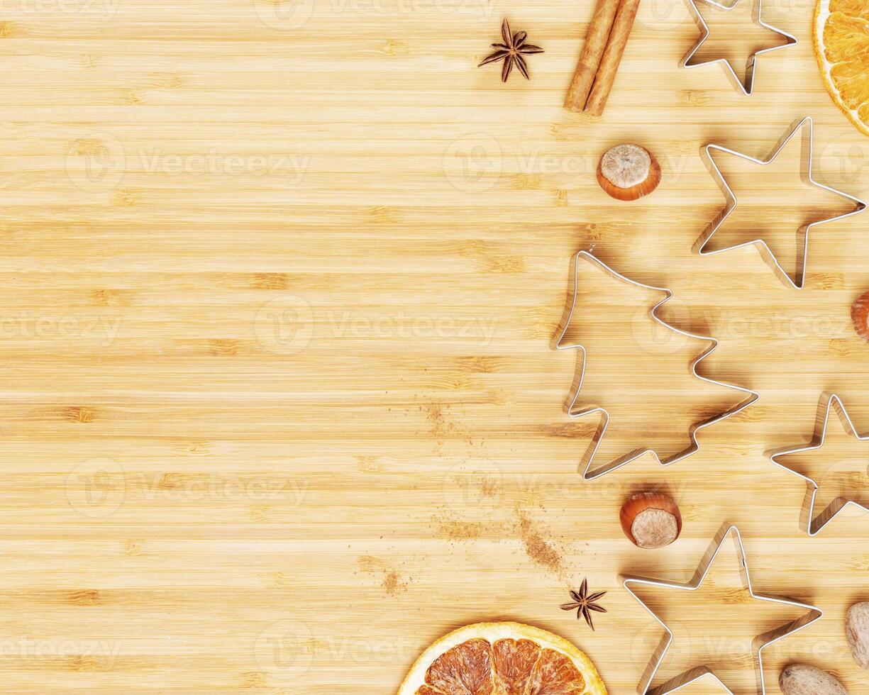 Christmas and New Year background with cookie cutters and dried fruits photo