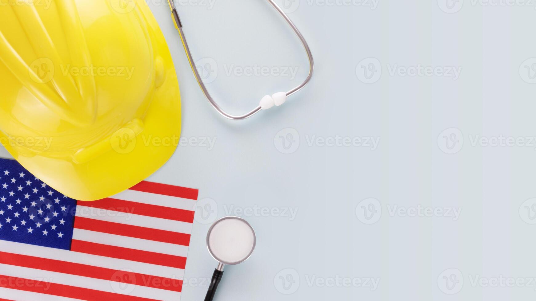 American flag, stethoscope and hardhat on a blue background photo